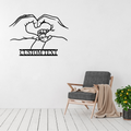 Made for Us personalised hands and heart metal wall art displayed above a contemporary chair in a stylish modern interior