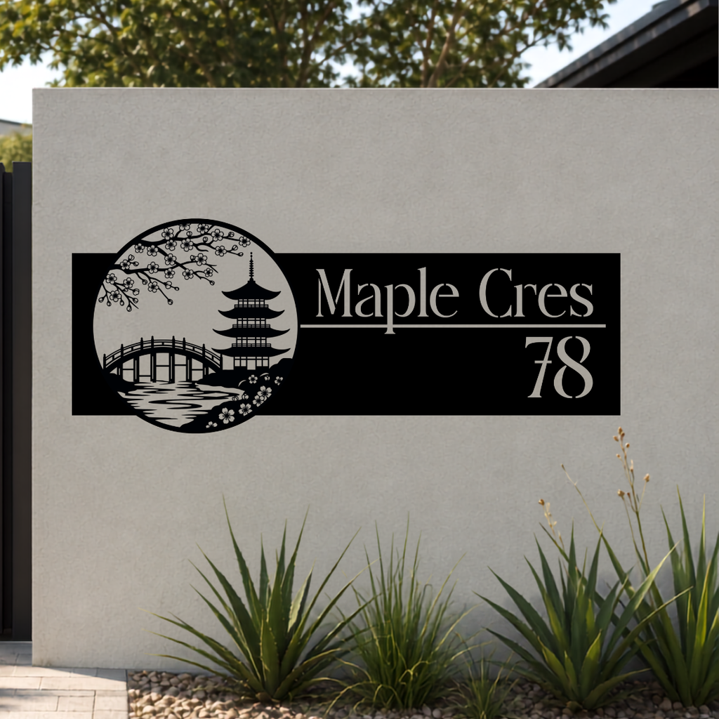 Maple Crescent Japanese Garden custom metal house number sign mounted on a modern rendered boundary wall beside a black aluminium sliding gate.