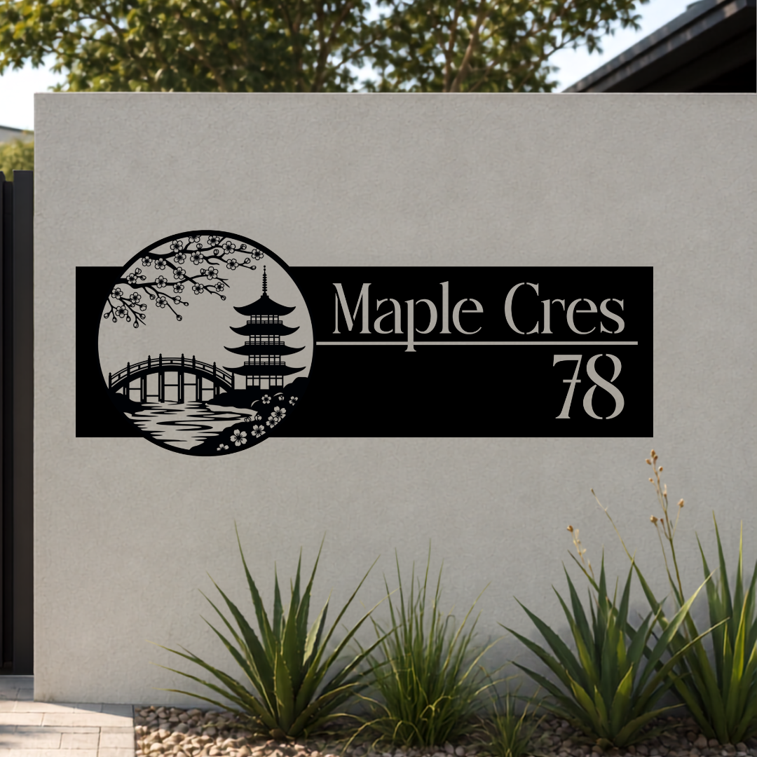 Maple Crescent Japanese Garden custom metal house number sign mounted on a modern rendered boundary wall beside a black aluminium sliding gate.
