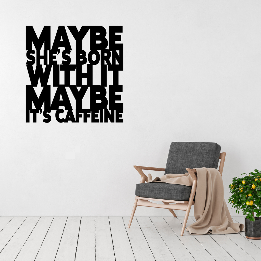 Maybe She's Born With It… Maybe It's Caffeine | Funny Coffee Metal Wall Art displayed above a modern accent chair in a contemporary living space.