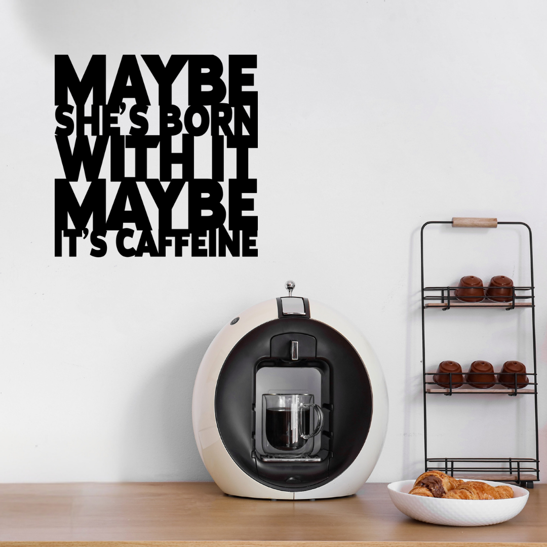 Maybe She's Born With It… Maybe It's Caffeine | Funny Coffee Metal Wall Art showcased above a stylish home coffee station with an espresso machine and coffee accessories.