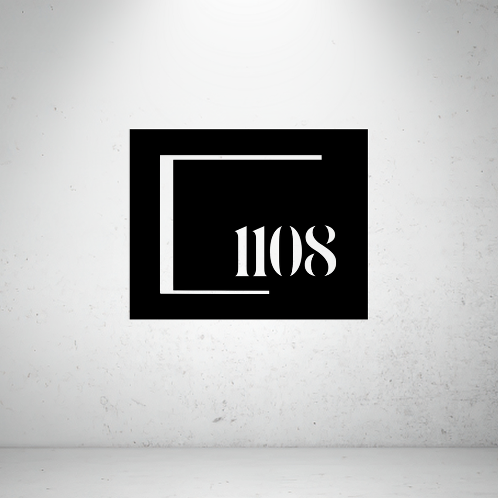 Modern framed metal house number sign featuring a custom address number within a minimalist open-frame design.