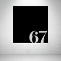 Metal house number sign with oversized modern numbers on a grey background