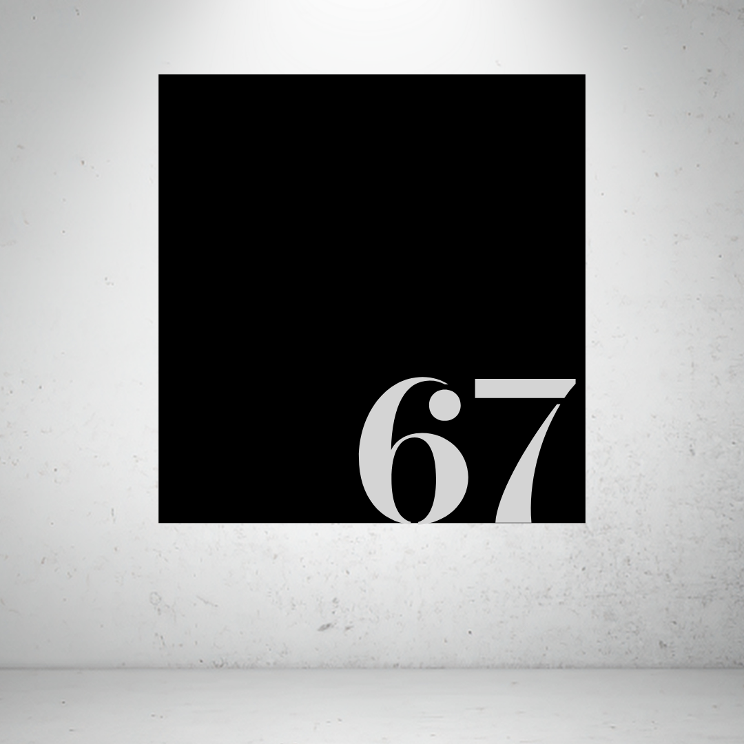 Metal house number sign with oversized modern numbers on a grey background