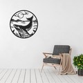 Ocean Giant | Whale Breach Metal Wall Art showcased as a statement piece in a contemporary coastal living room, featuring an elegant humpback whale, ocean horizon, flying seabirds, and sunset in a circular black metal wall art design.