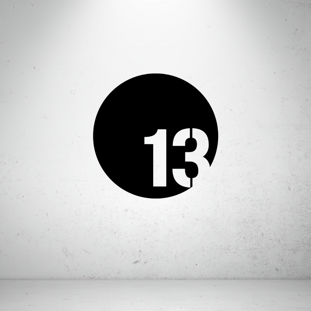 Modern circular metal house number sign with a bold offset custom number in a minimalist design.