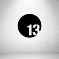 Modern circular metal house number sign with a bold offset custom number in a minimalist design.
