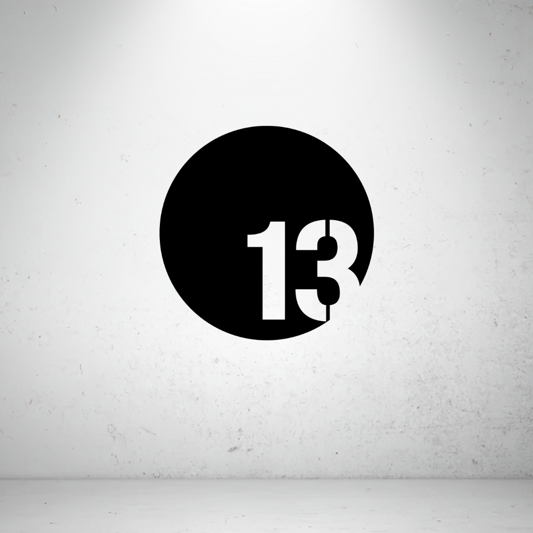 Modern circular metal house number sign with a bold offset custom number in a minimalist design.