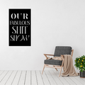 Modern black Our Fabulous Shit Show typography metal wall art displayed in a contemporary living room beside a lounge chair.