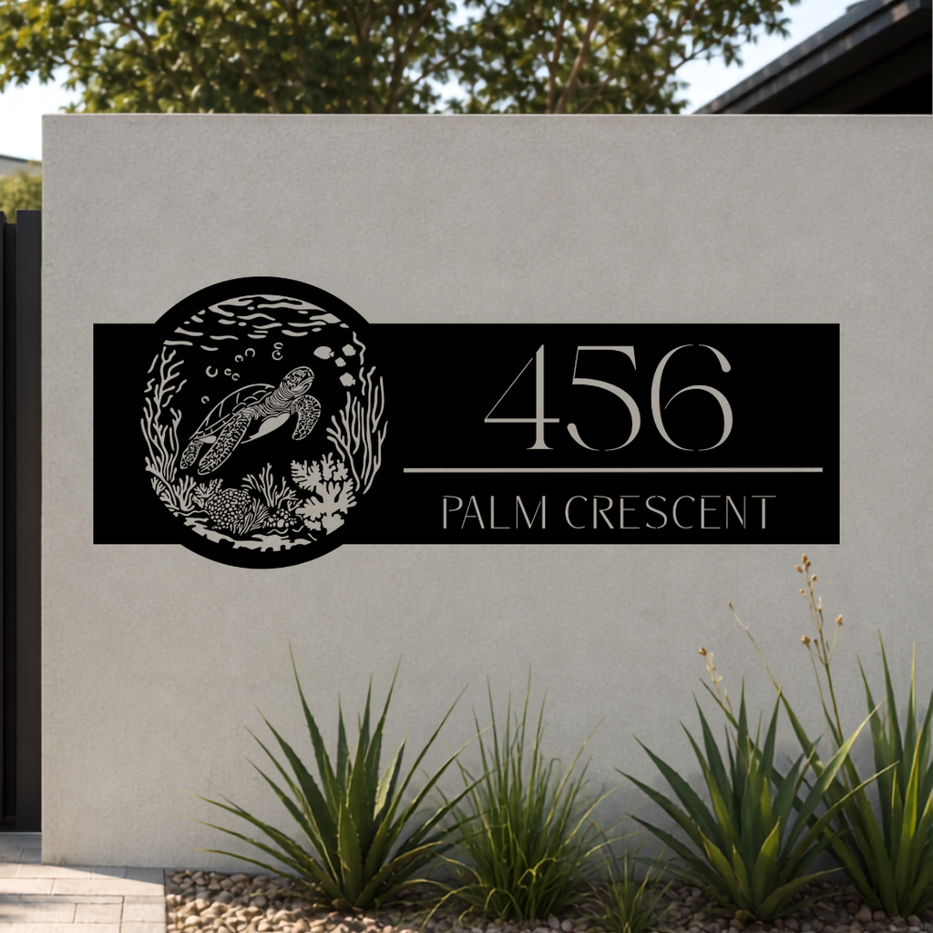 Palm Crescent personalised sea turtle metal address sign installed on a modern rendered boundary wall beside a contemporary entrance.