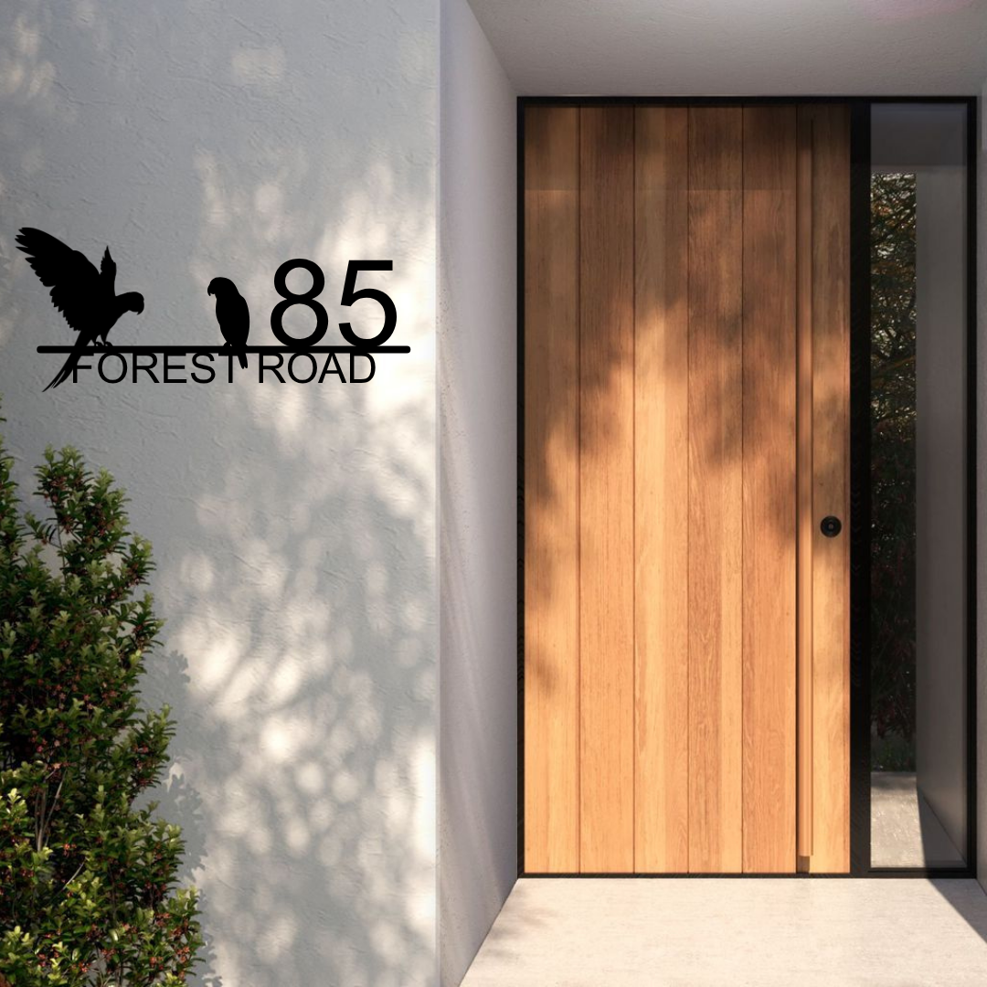 Metal house number parrot address sign installed at a tropical-style house entrance