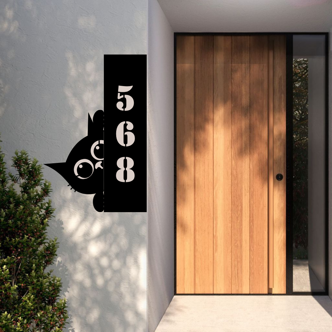 Metal house number cat-themed address sign displayed at a modern home entrance