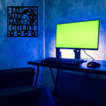 Gaming room metal wall sign displayed above a modern gamer setup