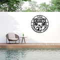 Tropical metal wall art displayed beside a luxury outdoor pool area