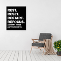 Reset & Refocus motivational metal wall art displayed on a bright modern interior wall.