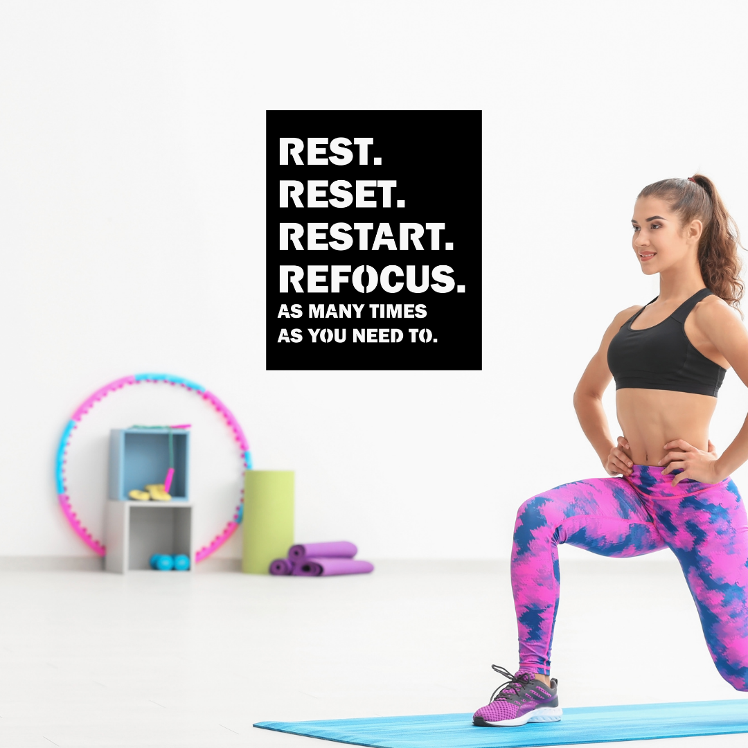 Reset & Refocus inspirational metal wall art showcased in a bright home gym workout space.