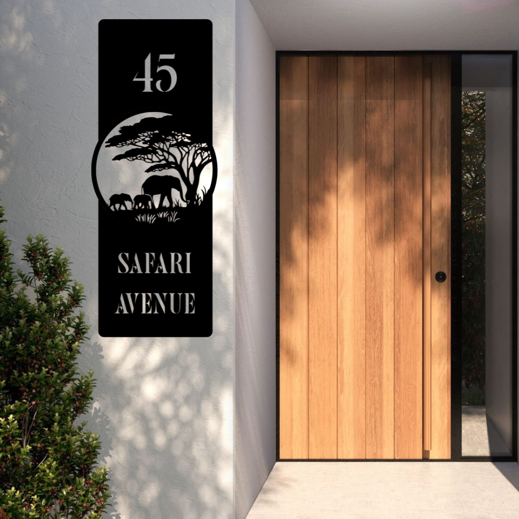 Safari Avenue African Elephant Family custom vertical house number sign installed beside a modern timber front door on a rendered exterior wall.