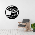 Savanna Serenity | Elephant Family Circular Metal Wall Art displayed on a modern living room wall, featuring an elephant family walking through the African savanna beneath acacia trees in elegant black metal.
