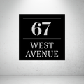 Metal house number and street name sign on a grey background with bold modern typography