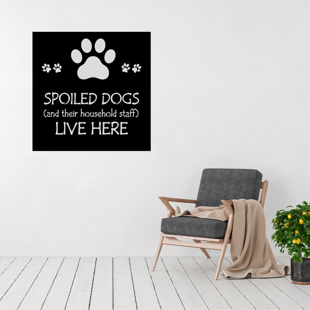 Spoiled Dogs Live Here funny dog metal sign displayed on a modern interior wall.
