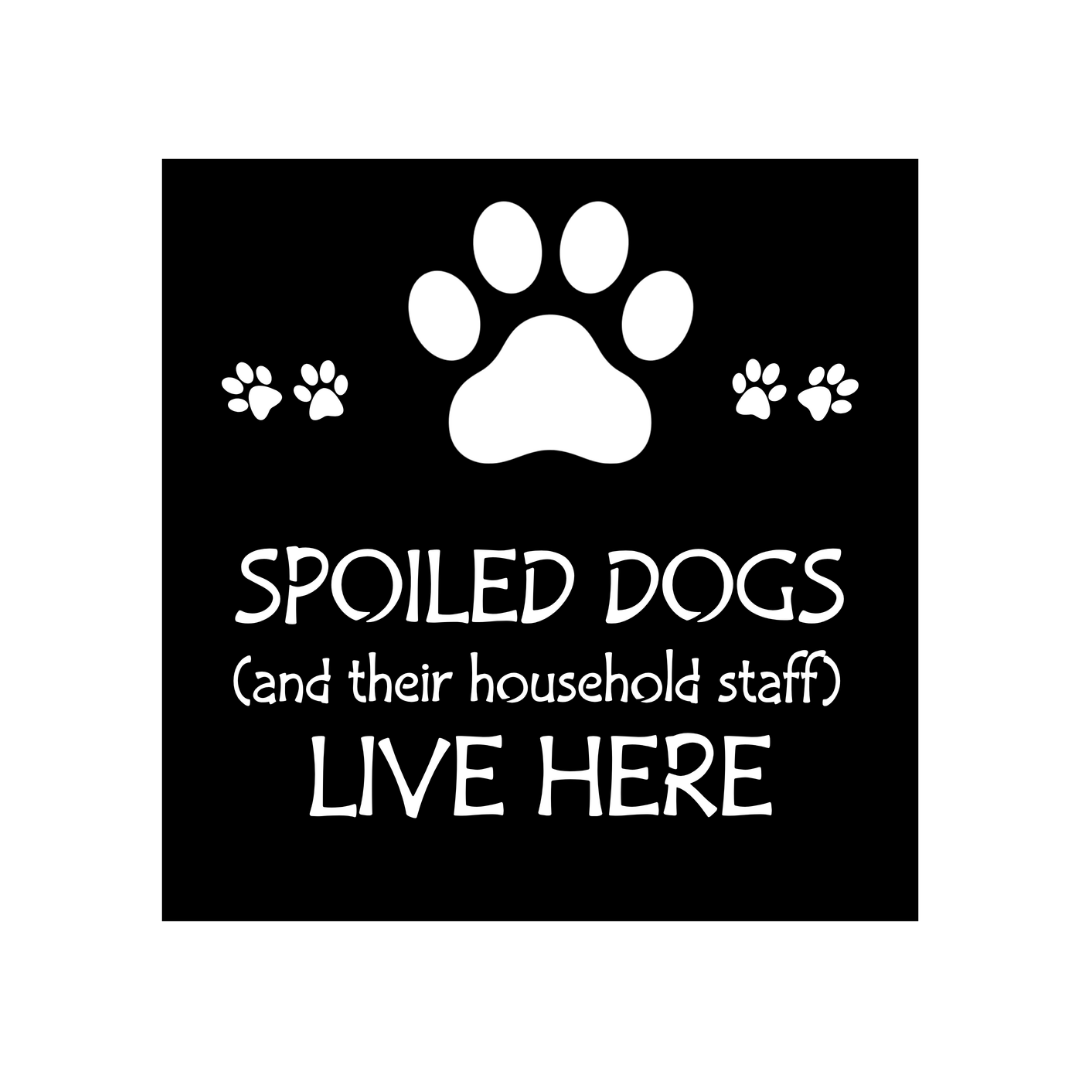Close-up of the Spoiled Dogs Live Here laser-cut metal sign featuring paw prints and humorous typography.