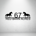 Metal house number farm sign with horse silhouettes on a grey background