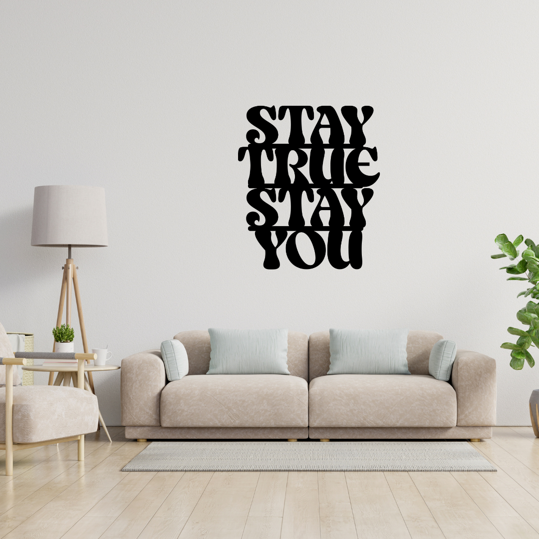Stay True Stay You motivational metal wall art displayed above a contemporary sofa, creating a stylish and inspiring focal point in a modern living room.