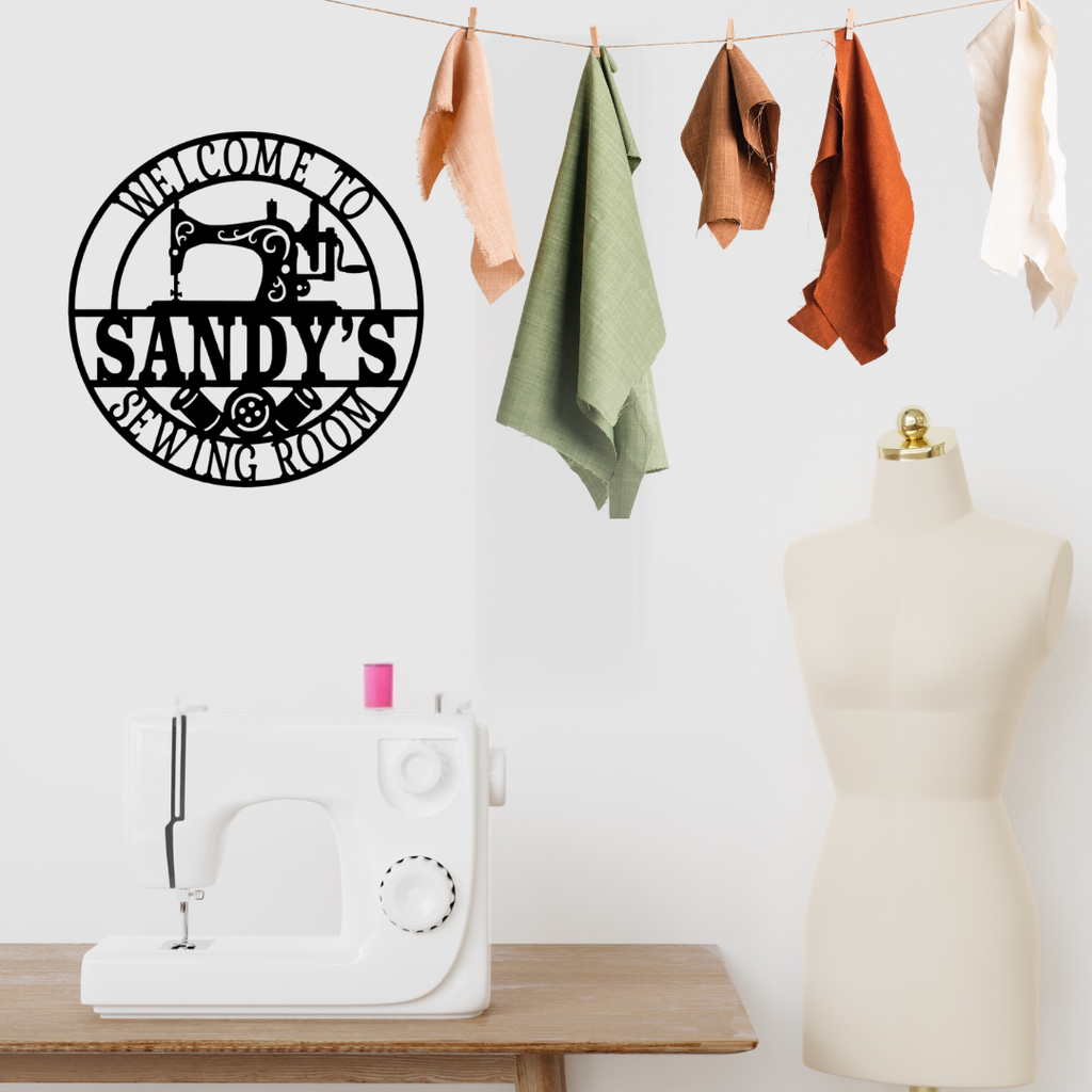 Sewing-themed metal décor styled above a craft workspace table