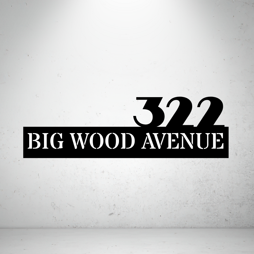 Metal house number sign with bold typography on a grey background