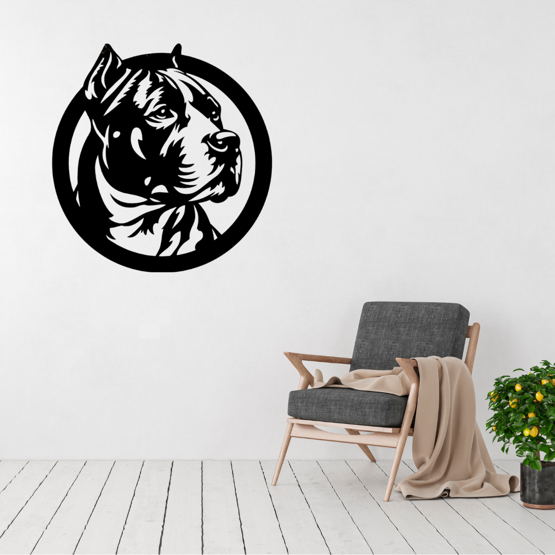Strength & Loyalty | Circular Pitbull Metal Wall Art displayed on a modern living room wall above a grey accent chair, featuring a detailed side-profile Pitbull portrait within a bold circular black metal frame.