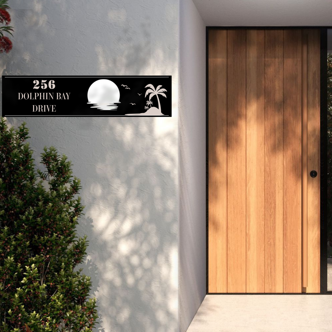Metal house number sunset address sign mounted at a tropical-style house entrance