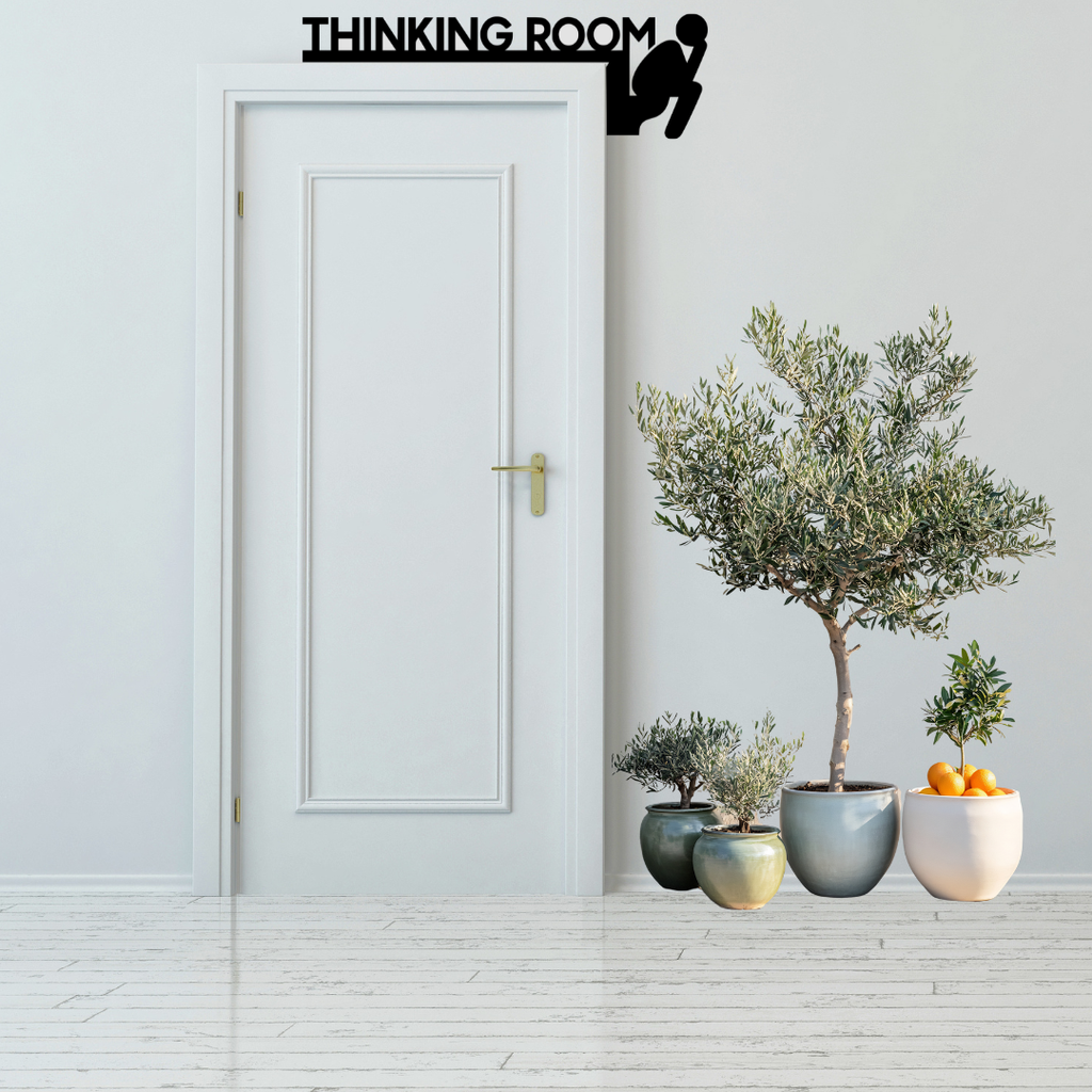 Thinking Room Humorous Bathroom Door Sign mounted above a modern white bathroom door.