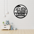 Lion cub metal wall art hanging in a safari-themed nursery room