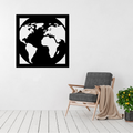 Wanderlust World | World Map Metal Wall Art displayed on a modern living room wall above a grey accent chair, featuring a minimalist world map within a contemporary square black metal frame.