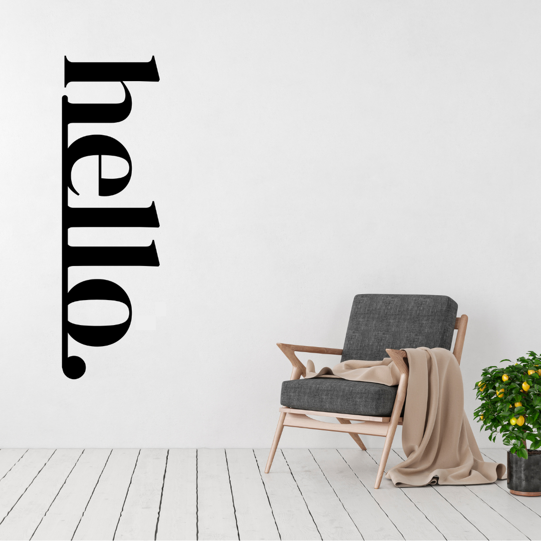 Warm Welcome | HELLO Vertical Metal Wall Sign displayed in a bright modern living room.