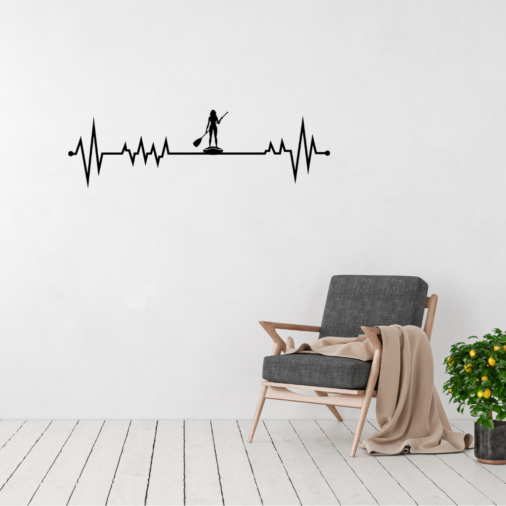 Waterbound | Hers SUP Heartbeat Metal Wall Art displayed in a modern living room.
