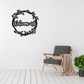 Welcome-ish | Humorous Metal Welcome Sign displayed in a bright modern living space, featuring a playful "Welcome-ish" script surrounded by a rustic leafy wreath