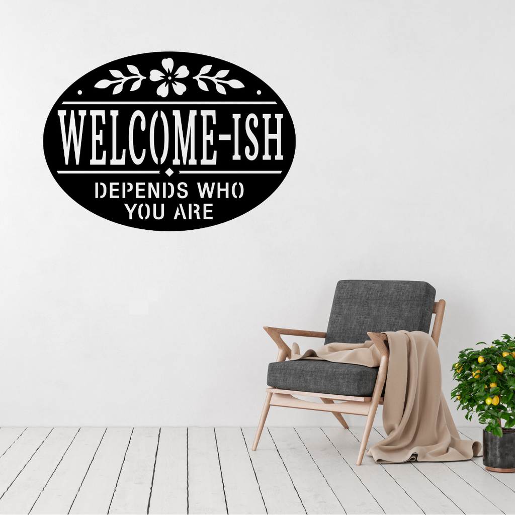 Welcome-ish humorous metal wall sign displayed above a contemporary chair in a modern interior