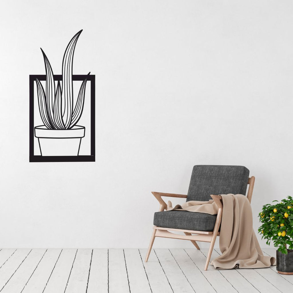 Metal snake plant wall art displayed in a minimalist modern interior