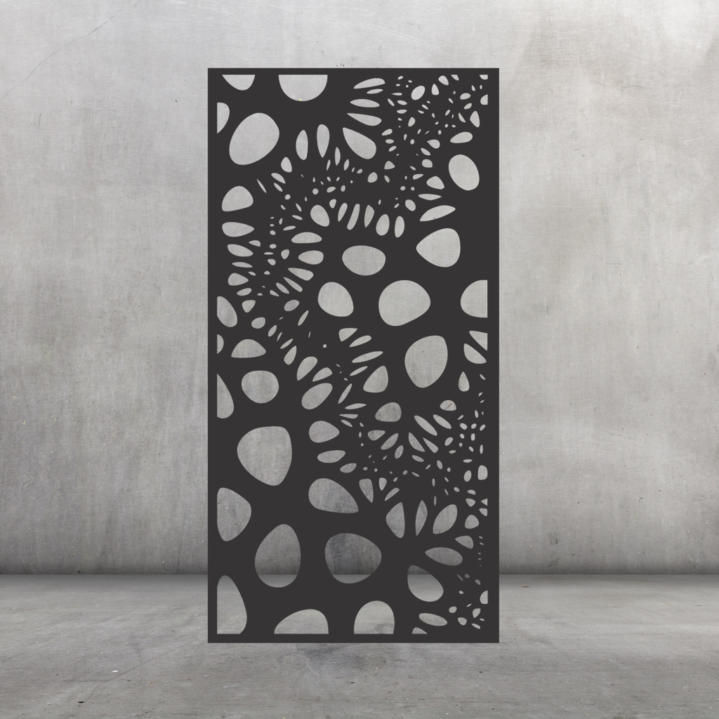 Wildwood botanical metal privacy screen displayed against a dark grey wall with flowing leaf and foliage-inspired cut-outs