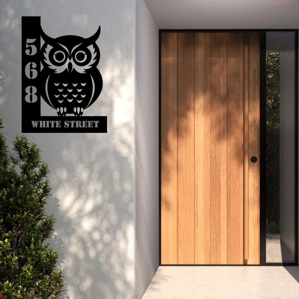 Metal house number owl sign displayed at a stylish house entrance