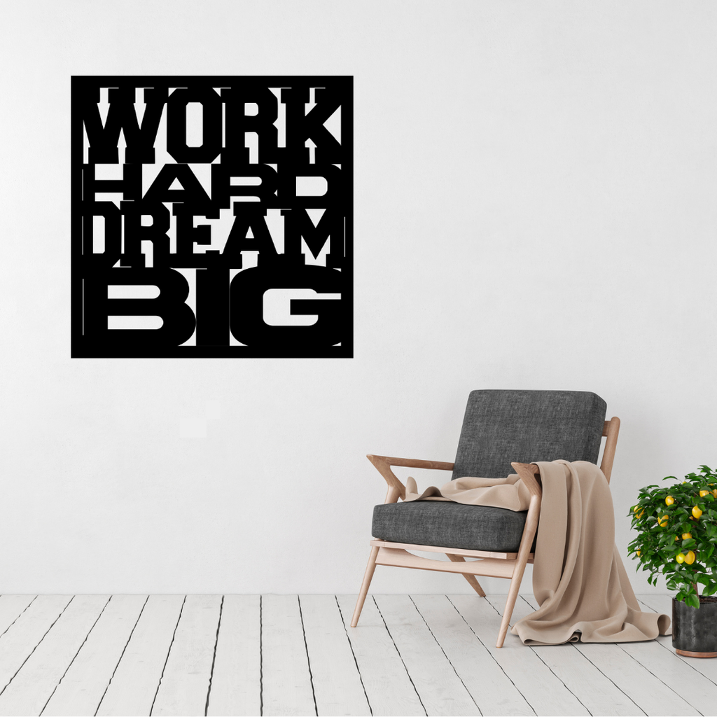 Work Hard Dream Big motivational metal wall art displayed above a modern accent chair in a bright contemporary living room.