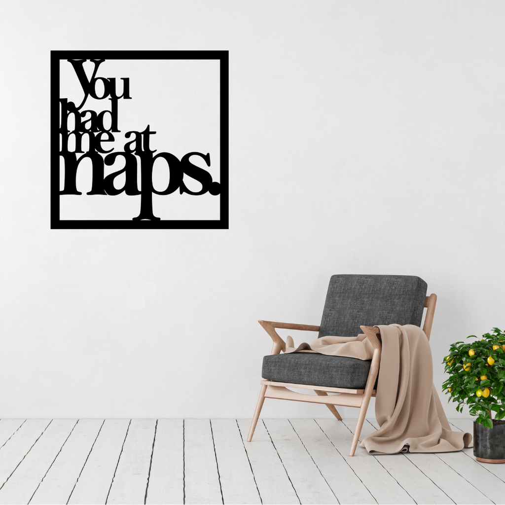 You Had Me at Naps | Funny Sleep Metal Wall Art displayed in a modern living space above a contemporary accent chair.