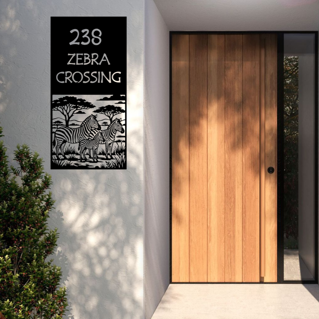 Zebra Crossing personalised safari house number sign installed on a modern rendered entrance wall beside a contemporary front door.